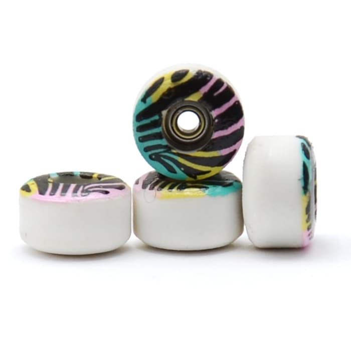 Four Finga urethane fingerboard wheels with a zebra-print graphic, in a macro product shot.