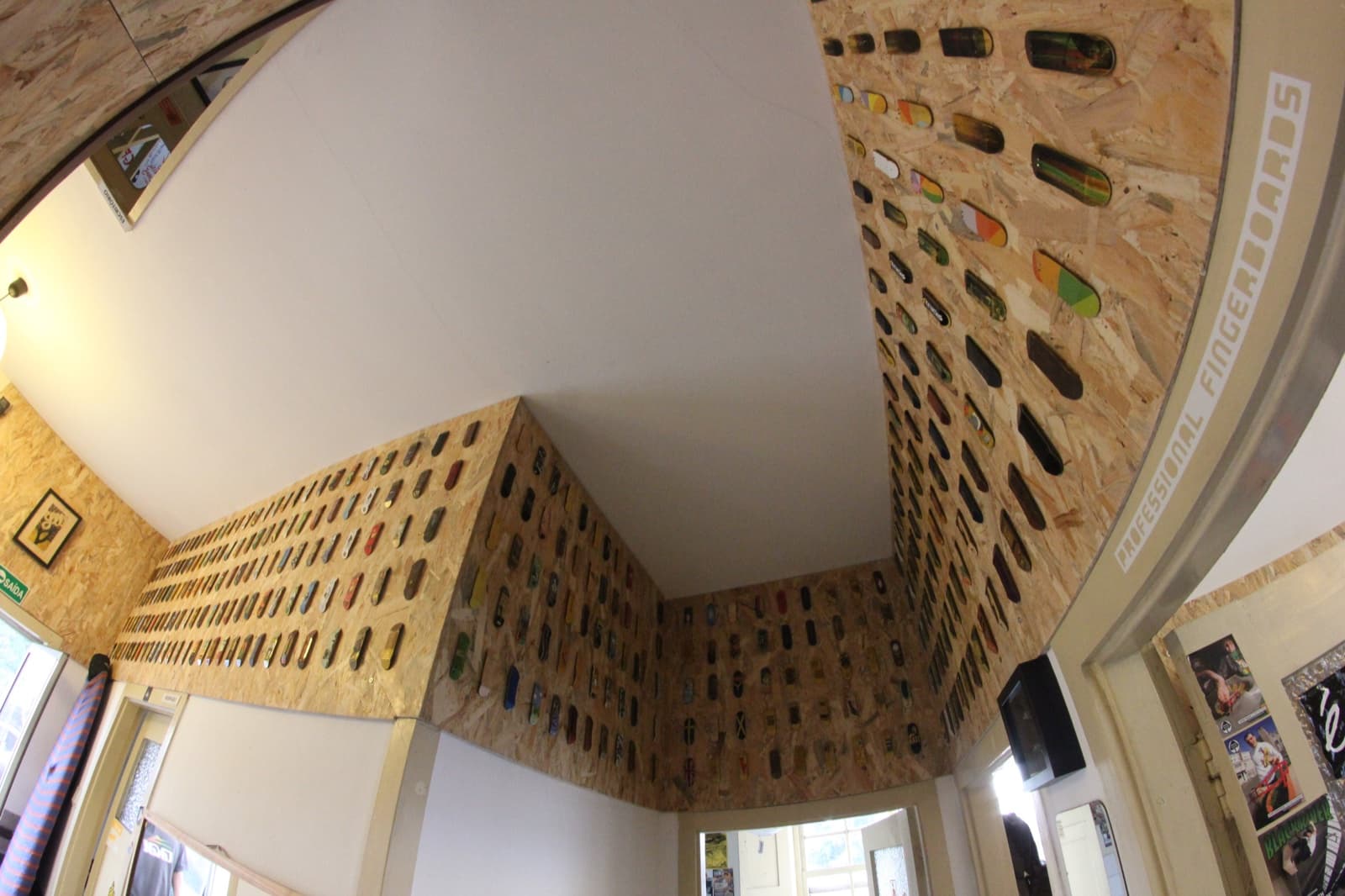Inside the Yellowood store, its walls covered edge to edge with mounted fingerboard decks.