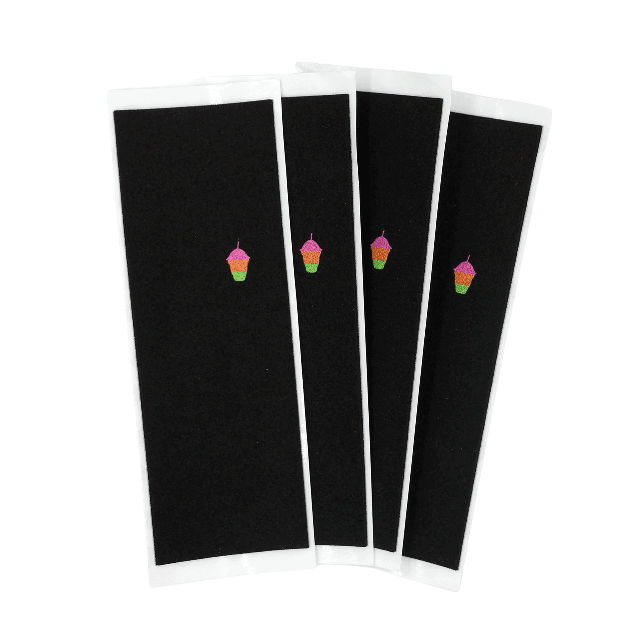 Four sheets of black fingerboard grip tape fanned out on white backing paper, each printed with a small pink, orange and green slush-cup graphic
