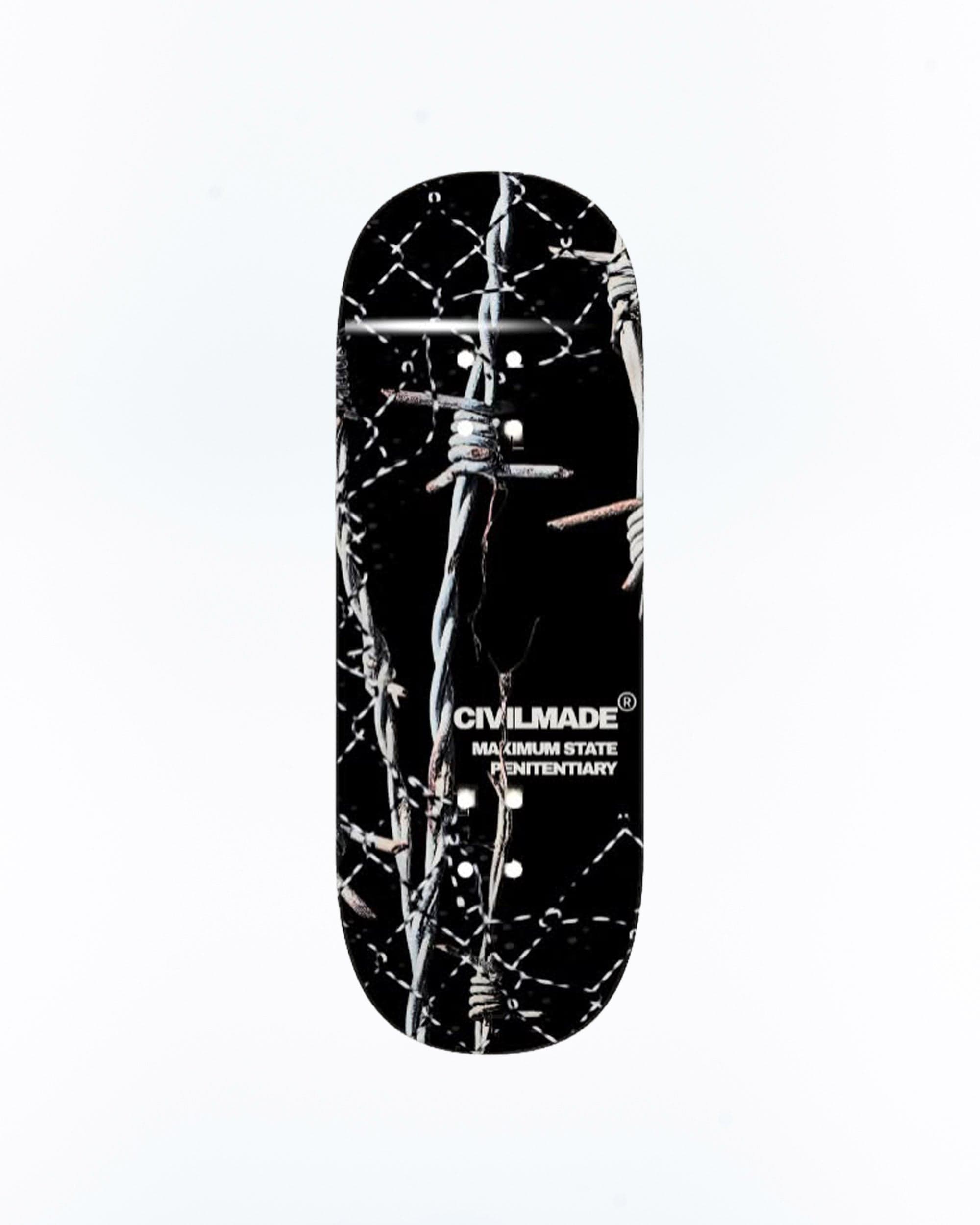 A black fingerboard deck with a barbed-wire graphic and the text “CIVILMADE MAXIMUM STATE PENITENTIARY” on a white background.